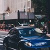 pexels-photo-1467476-1467476 Blue Volkswagen Beetle driving on Paulista Avenue, São Paulo's urban scene.